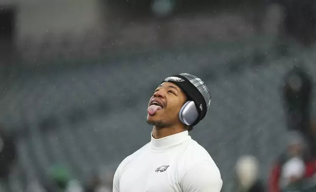 Philadelphia Eagles linebacker Nolan Smith Jr. sticks his tongue out as it snows before an NFL football NFC divisional playoff game against the Los Angeles Rams on Sunday, Jan. 19, 2025, in Philadelphia. (AP Photo/Matt Slocum)