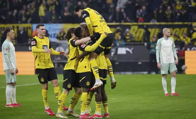 Dortmund's players celebrate after Bremen's own goal during the Bundesliga soccer match between Borussia Dortmund and Werder Bremen at Signal Iduna Park, Dortmund, Germany, Saturday Jan. 25, 2025. (Bernd Thissen/dpa via AP)