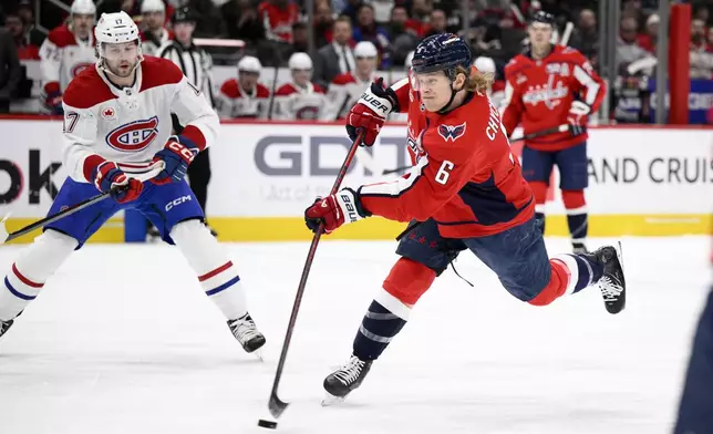 Washington Capitals defenseman Jakob Chychrun (6) shoots against Montreal Canadiens right wing Josh Anderson (17) during the first period of an NHL hockey game, Friday, Jan. 10, 2025, in Washington. (AP Photo/Nick Wass)
