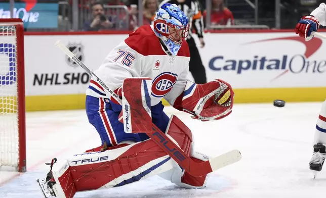 Montreal Canadiens goaltender Jakub Dobes (75) tracks the puck during the first period of an NHL hockey game against the Washington Capitals, Friday, Jan. 10, 2025, in Washington. (AP Photo/Nick Wass)