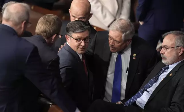 House Speaker Mike Johnson, R-La., speaks with Rep. Andy Harris, R-Md., right, and other members as the House of Representatives meets to elect a speaker and convene the new 119th Congress at the Capitol in Washington, Friday, Jan. 3, 2025. (AP Photo/Mark Schiefelbein)