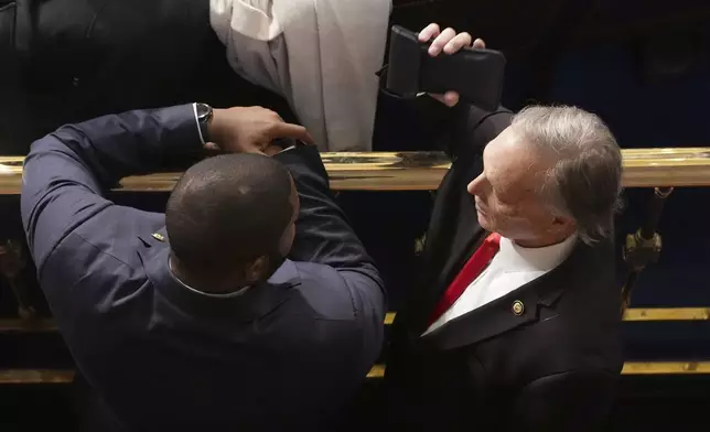 Rep. Byron Donalds, R-Fla., left, and Rep. Andy Biggs, R-Ariz., speak as the House of Representatives meets to elect a speaker and convene the new 119th Congress at the Capitol in Washington, Friday, Jan. 3, 2025. (AP Photo/Jacquelyn Martin)