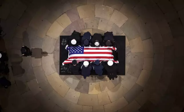 The flag-draped casket of former President Jimmy Carter lies in state at the rotunda of the U.S. Capitol Tuesday, Jan. 7, 2025, in Washington. (Andrew Harnik/Pool via AP)