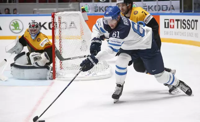 FILE - Aleksander Barkov of Finland, left, fights for the puck with Germany's Darylboyle during the Hockey World Championships Group B match in St. Petersburg, Russia, Sunday, May 8, 2016. (AP Photo/Dmitri Lovetsky, File)