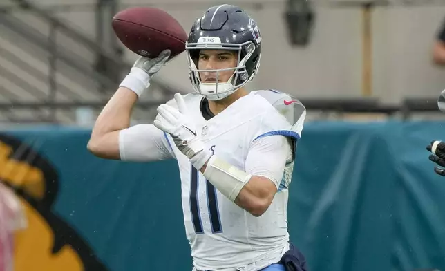 Tennessee Titans quarterback Mason Rudolph (11) looks to throw a pass during the first half of an NFL football game against the Jacksonville Jaguars, Sunday, Dec. 29, 2024, in Jacksonville, Fla. (AP Photo/John Raoux)