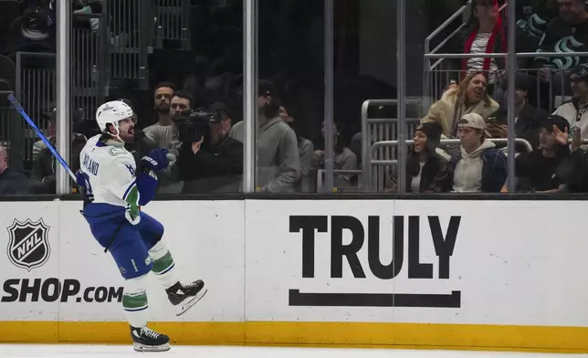 Vancouver Canucks right wing Conor Garland reacts to scoring against the Seattle Kraken during the second period of an NHL hockey game Thursday, Jan. 2, 2025, in Seattle. (AP Photo/Lindsey Wasson)