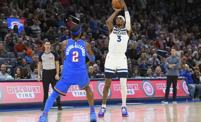 Minnesota Timberwolves forward Jaden McDaniels (3) shoots over Oklahoma City Thunder guard Shai Gilgeous-Alexander (2) during the second half of an NBA basketball game, Tuesday, Dec. 31, 2024, in Oklahoma City. (AP Photo/Kyle Phillips)