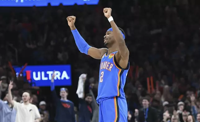 Oklahoma City Thunder guard Shai Gilgeous-Alexander celebrates after a basket during the first half of an NBA basketball game against the Minnesota Timberwolves, Tuesday, Dec. 31, 2024, in Oklahoma City. (AP Photo/Kyle Phillips)