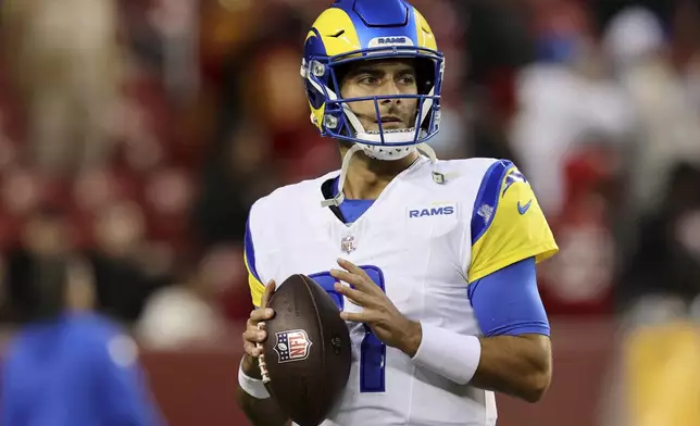 FILE - Los Angeles Rams quarterback Jimmy Garoppolo warms up during an NFL football game against the San Francisco 49ers, Dec. 12, 2024, in Santa Clara, Calif. (AP Photo/Scot Tucker, File)