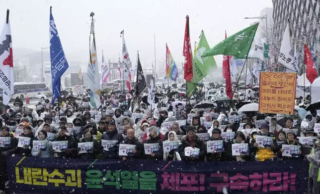 Protesters stage a rally demanding the arrest of impeached South Korean President Yoon Suk Yeol near the presidential residence in Seoul, South Korea, Sunday, Jan. 5, 2025. The letters read "Arrest Yoon Suk Yeol." (AP Photo/Ahn Young-joon)