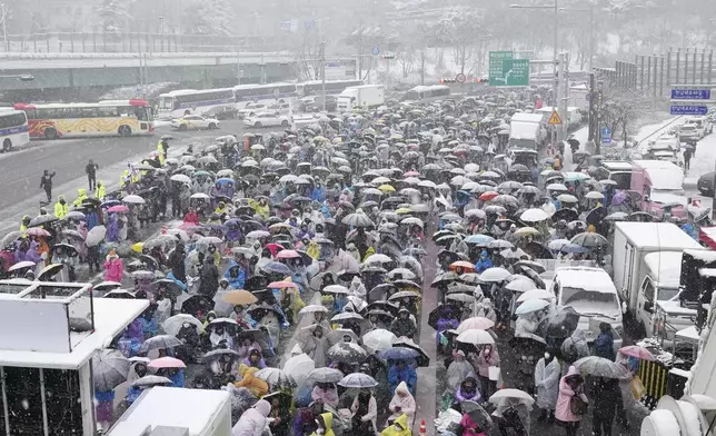 Supporters of impeached South Korean President Yoon Suk Yeol attend a Sunday service as they gather to oppose his impeachment near the presidential residence in Seoul, South Korea, Sunday, Jan. 5, 2025. (AP Photo/Ahn Young-joon)