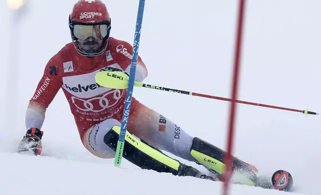 Switzerland's Loic Meillard speeds down the course during an alpine ski, men's World Cup slalom race, in Adelboden, Switzerland, Saturday, Jan. 11, 2025. (AP Photo/Gabriele Facciotti)