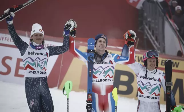 From left, second placed Brazil' Lucas Braathen, the winner France's Clement Noel and third placed Norway's Henrik Kristoffersen celebrate after an alpine ski, men's World Cup slalom race, in Adelboden, Switzerland, Saturday, Jan. 11, 2025. (AP Photo/Gabriele Facciotti)