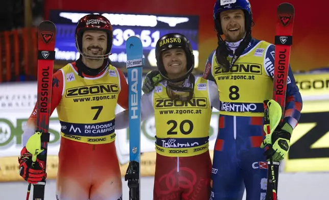 Bulgaria's Albert Popov, center, winner of an alpine ski, men's World Cup slalom, poses with second placed Switzerland's Loic Meillard, left, and third placed Croatia's Samuel Kolega, in Madonna di Campiglio, Italy, Wednesday, Jan.8, 2025. (AP Photo/Alessandro Trovati)