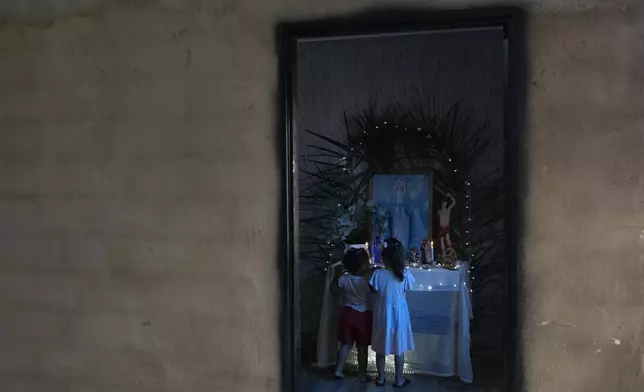 Children look at Our Lady's altar, during a procession marking Epiphany, or Three Kings Day, in Santo Antonio de Goias, Brazil, Sunday, Jan. 5, 2025. (AP Photo/Eraldo Peres)