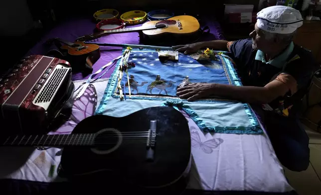 Musician and singer Jose Paulo celebrates the flag of the Holy Kings during a procession marking Epiphany, or Three Kings Day, in Santo Antonio de Goias, Brazil, Saturday, Jan. 4, 2025. (AP Photo/Eraldo Peres)