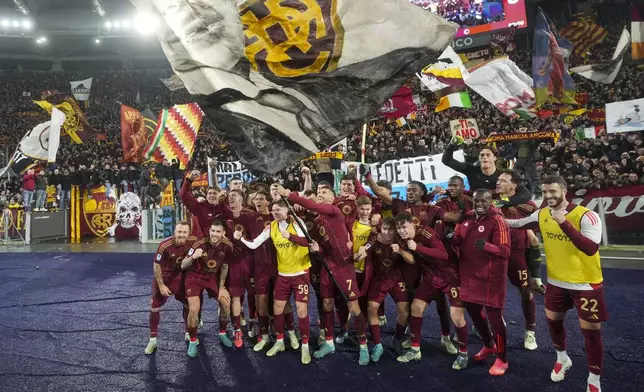 Roma players celebrate at the end of a Serie A soccer match between Roma and Lazio, at the Stadio Olimpico in Rome, Italy, Sunday, Jan. 5, 2025. (AP Photo/Alessandra Tarantino)