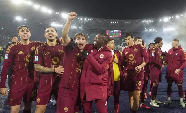 Roma players celebrate at the end of a Serie A soccer match between Roma and Lazio, at the Stadio Olimpico in Rome, Italy, Sunday, Jan. 5, 2025. (AP Photo/Alessandra Tarantino)