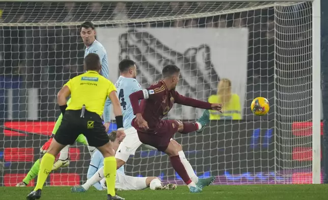 Roma's Lorenzo Pellegrini, center, scores his side's opening goal during a Serie A soccer match between Roma and Lazio, at the Stadio Olimpico in Rome, Italy, Sunday, Jan. 5, 2025. (AP Photo/Alessandra Tarantino)