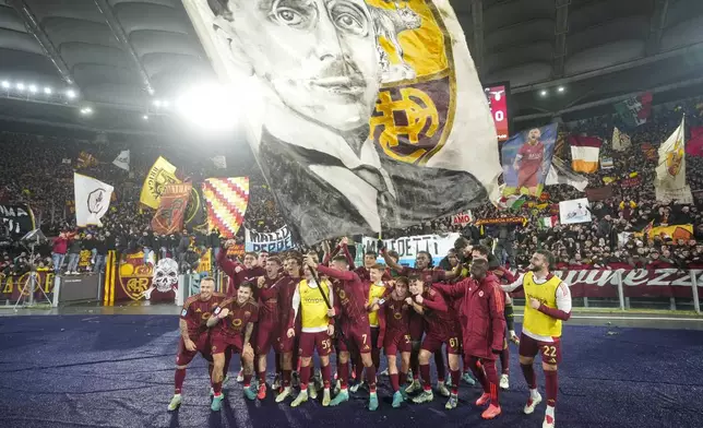 Roma players celebrate at the end of a Serie A soccer match between Roma and Lazio, at the Stadio Olimpico in Rome, Italy, Sunday, Jan. 5, 2025. (AP Photo/Alessandra Tarantino)