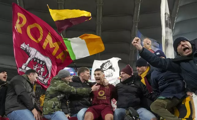 Roma's Lorenzo Pellegrini, center, celebrates with fans at the end of a Serie A soccer match between Roma and Lazio, at the Stadio Olimpico in Rome, Italy, Sunday, Jan. 5, 2025. (AP Photo/Alessandra Tarantino)