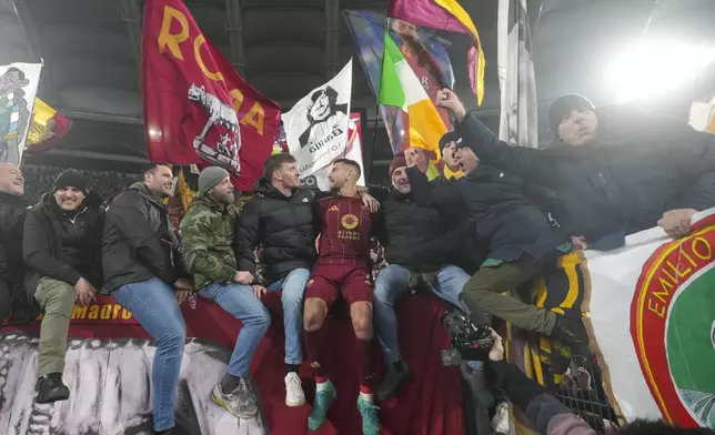 Roma's Lorenzo Pellegrini, center, celebrates with fans at the end of a Serie A soccer match between Roma and Lazio, at the Stadio Olimpico in Rome, Italy, Sunday, Jan. 5, 2025. (AP Photo/Alessandra Tarantino)