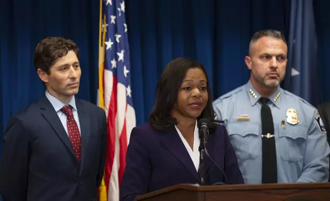 Assistant Attorney General Kristen Clarke of the Justice Department's Civil Rights Division, flanked by Minneapolis Mayor Jacob Frey, left, and Chief Brian O'Hara of the Minneapolis Police Department, speaks at a news conference after the Minneapolis City Council approved a settlement agreement with the U.S. Department of Justice approving a federal consent decree, at the U.S. Courthouse in Minneapolis, Monday, Jan. 6, 2025. (Jeff Wheeler/Star Tribune via AP)