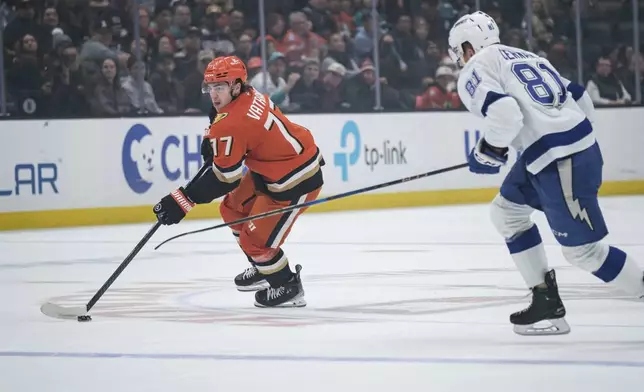 Anaheim Ducks right wing Frank Vatrano (77) looks to shoot the puck while Tampa Bay Lightning defenseman Erik Cernak (81) defends during the first period of an NHL hockey game Sunday, Jan. 5, 2025, in Anaheim, Calif. (AP Photo/William Liang)