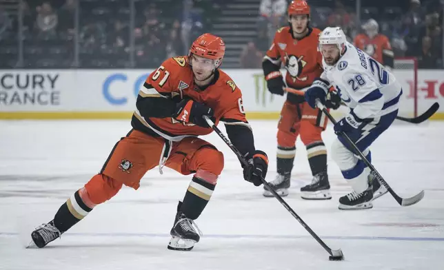 Anaheim Ducks left wing Cutter Gauthier (61) looks to pass the puck during the first period of an NHL hockey game against the Tampa Bay Lightning, Sunday, Jan. 5, 2025, in Anaheim, Calif. (AP Photo/William Liang)