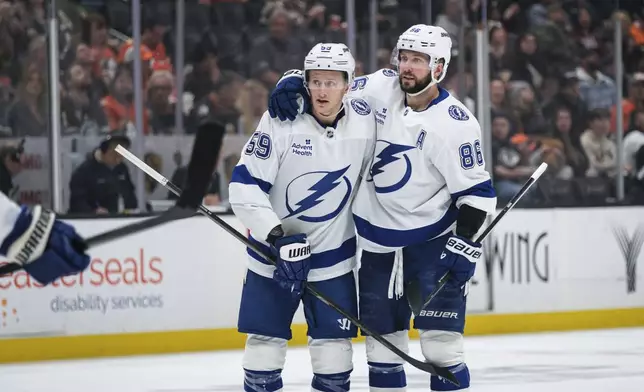 Tampa Bay Lightning center Jake Guentzel (59) celebrates after his goal with right wing Nikita Kucherov (86) during the second period of an NHL hockey game against the Anaheim Ducks, Sunday, Jan. 5, 2025, in Anaheim, Calif. (AP Photo/William Liang)