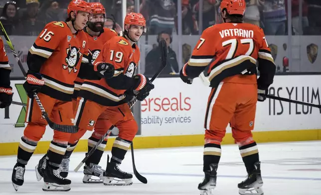 Anaheim Ducks players celebrate after a goal by right wing Troy Terry (19) during the first period of an NHL hockey game against the Tampa Bay Lightning, Sunday, Jan. 5, 2025, in Anaheim, Calif. (AP Photo/William Liang)