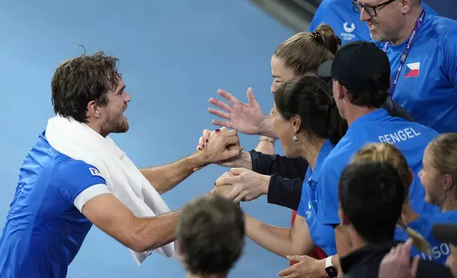 Czechia's Tomas Machac, left, celebrates with teammates after defeating Italy's Flavio Cobolli in their quarterfinal match at the United Cup tennis tournament in Sydney, Australia, Friday, Jan. 3, 2025. (AP Photo/Rick Rycroft)