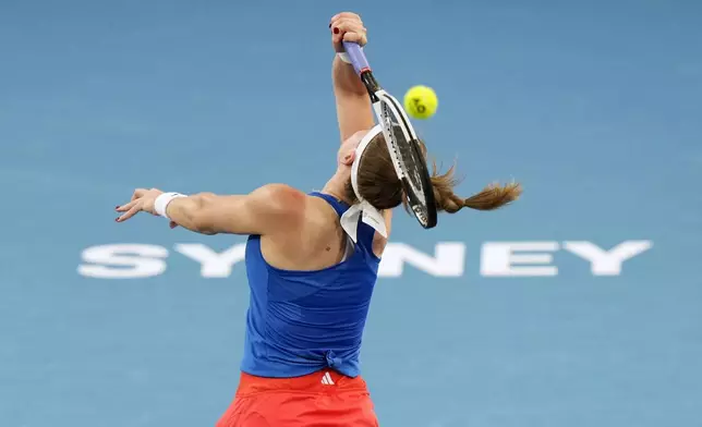 Czechia's Karolina Muchova plays an overhead shot to Italy's Jasmine Paolini during their quarterfinal match at the United Cup tennis tournament in Sydney, Australia, Friday, Jan. 3, 2025. (AP Photo/Rick Rycroft)