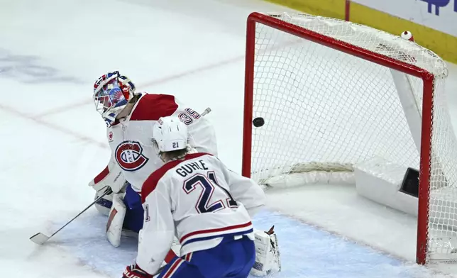 Montreal Canadiens goalie Sam Montembeault (35) misses a goal scored by Chicago Blackhawks' Nick Foligno (17) during the second period of an NHL hockey game Jan. 3, 2025, in Chicago. (AP Photo/Paul Beaty)