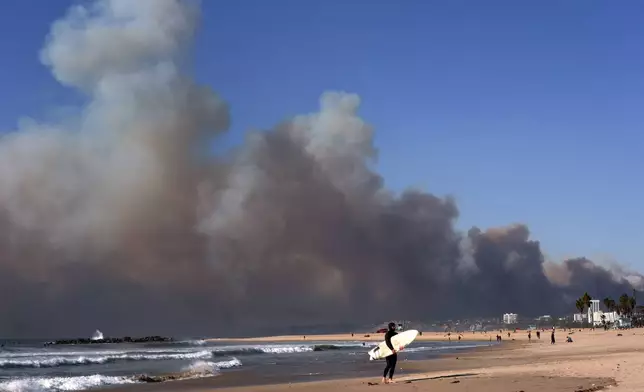 Smoke from a wildfire is seen from the Venice Beach section of Los Angeles, Tuesday, Jan. 7, 2025. (AP Photo/Jae C. Hong)