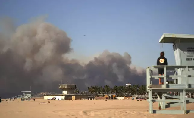 Smoke from a wildfire is seen from the Venice Beach section of Los Angeles, Tuesday, Jan. 7, 2025. (AP Photo/Jae C. Hong)