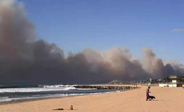 Smoke from a wildfire is seen from the Venice Beach section of Los Angeles, Tuesday, Jan. 7, 2025. (AP Photo/Jae C. Hong)