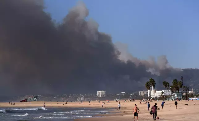 Smoke from a wildfire is seen from the Venice Beach section of Los Angeles, Tuesday, Jan. 7, 2025. (AP Photo/Jae C. Hong)