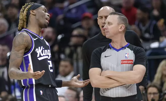 Sacramento Kings guard Keon Ellis, left, pleads with referee Justin Van Duyne, front right, after being called for a foul during the first half of an NBA basketball game against the Houston Rockets in Sacramento, Calif., Thursday, Jan. 16, 2025. (AP Photo/Randall Benton)