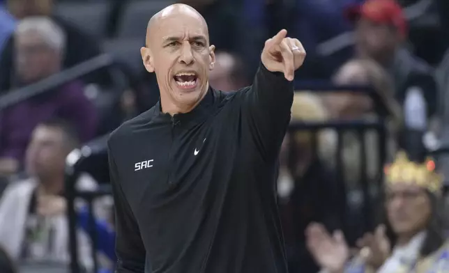 Sacramento Kings interim head coach Doug Christie shouts from the bench during the first half of an NBA basketball game against the Houston Rockets in Sacramento, Calif., Thursday, Jan. 16, 2025. (AP Photo/Randall Benton)