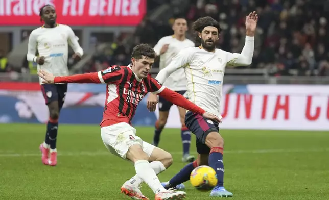 AC Milan's Christian Pulisic, left, attempts a shot on goal during the Serie A soccer match between AC Milan and Cagliari at the San Siro stadium, in Milan, Italy, Saturday, Jan. 11, 2025. (AP Photo/Antonio Calanni)