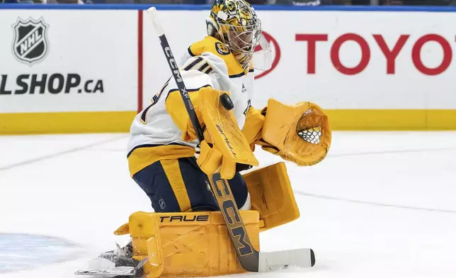 Nashville Predators goaltender Juuse Saros (74) stops the puck against the Vancouver Canucks during the first period of an NHL hockey game, Friday, Jan. 3, 2025 in Vancouver, British Columbia. (Ethan Cairns/The Canadian Press via AP)