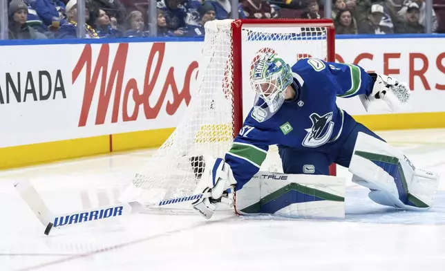 Vancouver Canucks goaltender Kevin Lankinen stops the puck during the second period of an NHL hockey game against the Nashville Predators in Vancouver, British Columbia, Friday, Jan. 3, 2025. (Ethan Cairns/The Canadian Press via AP)