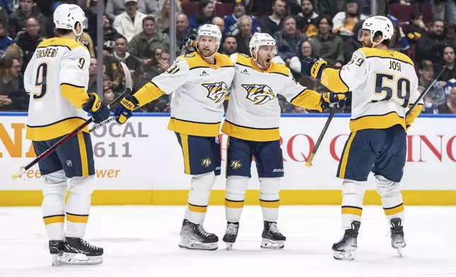 Nashville Predators Steven Stamkos (91), celebrates after his goal against the Vancouver Canucks with Filip Forsberg (9), Jonathan Marchessault (81), and Roman Josi (59) during the second period of an NHL hockey game in Vancouver, British Columbia, Friday, Jan. 3, 2025. (Ethan Cairns/The Canadian Press via AP)