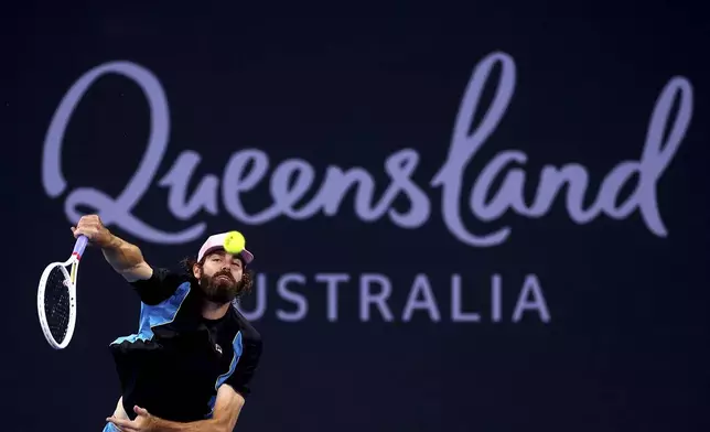 USA's Reilly Opelka plays serves to Serbia's Novak Djokovic during their match at the Brisbane International, in Brisbane, Australia, Friday, Jan. 3, 2025. (AP Photo/Pat Hoelscher)