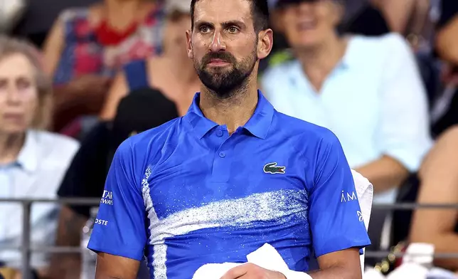 Serbia's Novak Djokovic looks on during his match against USA's Reilly Opelka at the Brisbane International, in Brisbane, Australia, Friday, Jan. 3, 2025. (AP Photo/Pat Hoelscher)