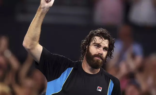 USA's Reilly Opelka celebrates winning his match against Serbia's Novak Djokovic at the Brisbane International, in Brisbane, Australia, Friday, Jan. 3, 2025. (AP Photo/Pat Hoelscher)