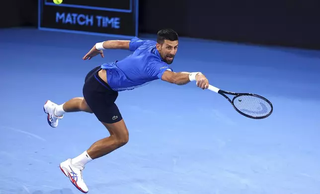 Serbia's Novak Djokovic returns a shot to USA's Reilly Opelka during their match at the Brisbane International, in Brisbane, Australia, Friday, Jan. 3, 2025. (AP Photo/Pat Hoelscher)