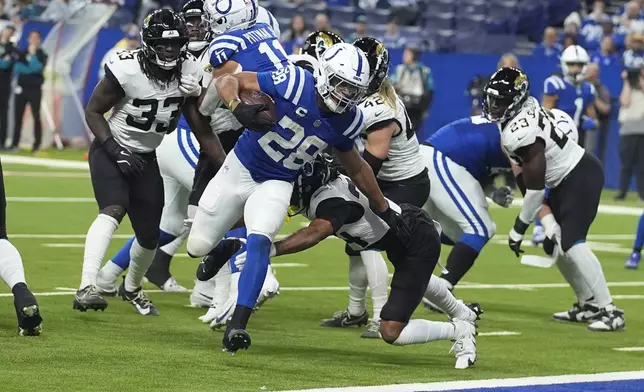 Indianapolis Colts running back Jonathan Taylor (28) runs for a touchdown past Jacksonville Jaguars cornerback De'Antre Prince (24) during the first half of an NFL football game, Sunday, Jan. 5, 2025, in Indianapolis. (AP Photo/Darron Cummings)