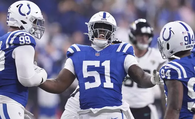 Indianapolis Colts defensive end Kwity Paye (51) celebrates sacking Jacksonville Jaguars quarterback Mac Jones with Indianapolis Colts defensive tackle DeForest Buckner (99) and Indianapolis Colts defensive end Tyquan Lewis (94) during the first half of an NFL football game, Sunday, Jan. 5, 2025, in Indianapolis. (AP Photo/Michael Conroy)